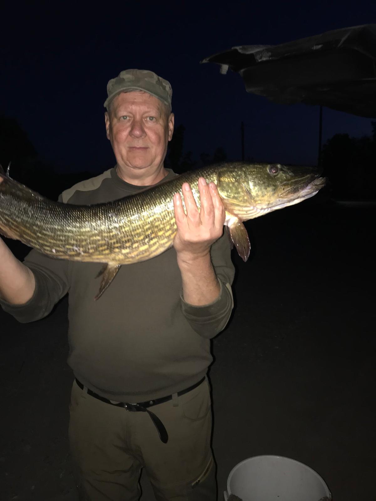 Angler with a large pike caught at Lake Białe